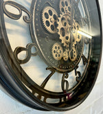 Lade das Bild in den Galerie-Viewer, Wanduhr Zahnrad Berlin Zählwerk Animation schwarz 55 cm
